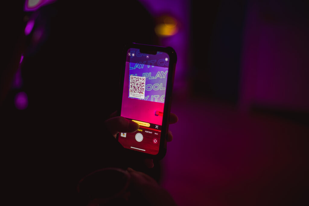 Scanning a QR code to access the Play It Cool Interactive Audio Visualizer on a smartphone screen.