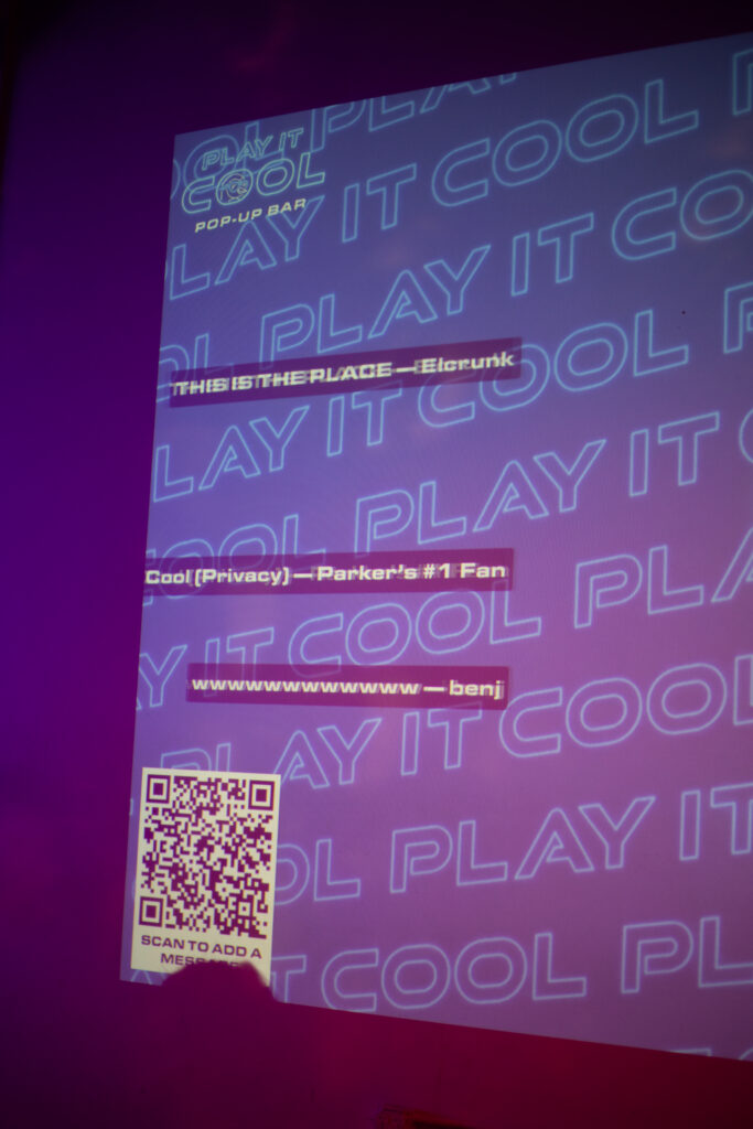 Play It Cool Pop-Up Bar" projection with text: "THIS IS THE PLACE —Electrunk," "Cool(Privacy) —Parker's #1 Fan," and "wwwwww —benj." Includes a QR code labeled "SCAN TO ADD A MESSAGE.
