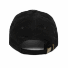 Back view of a black corduroy baseball cap featuring an adjustable strap and buckle.